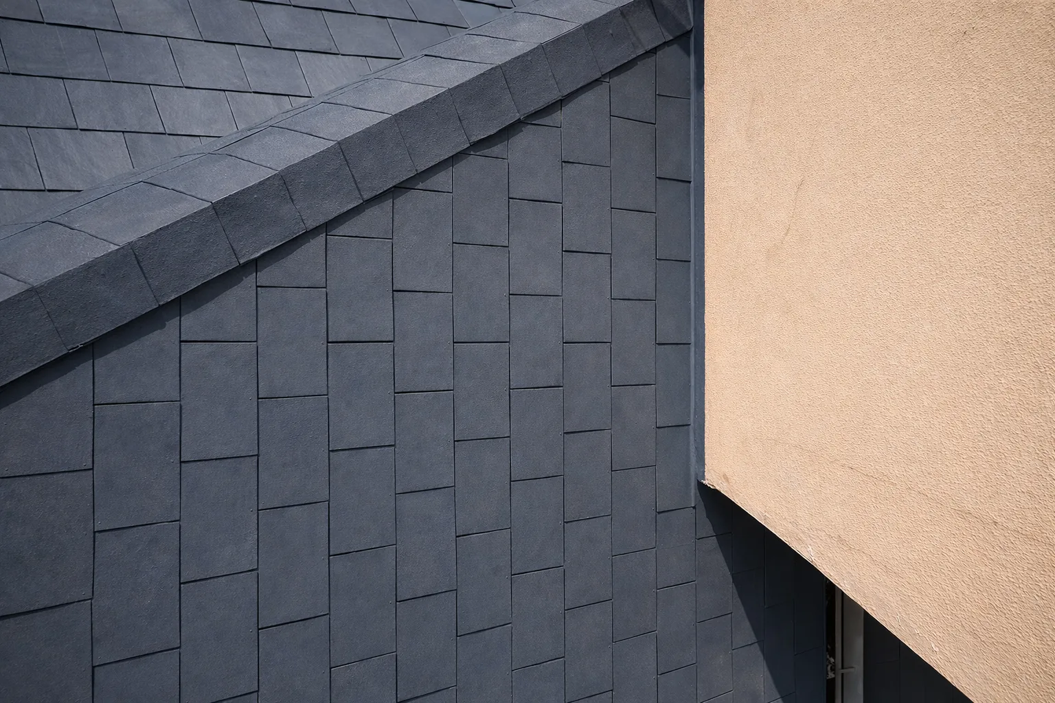 Close-up of repaired slate roof tiles and parapet on a Camps Bay home