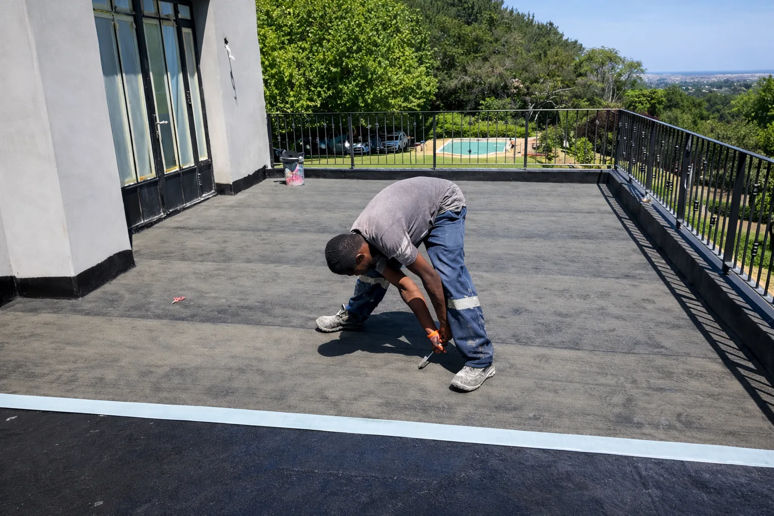 CBM applying deck waterproofing on a Constantia home above the garden