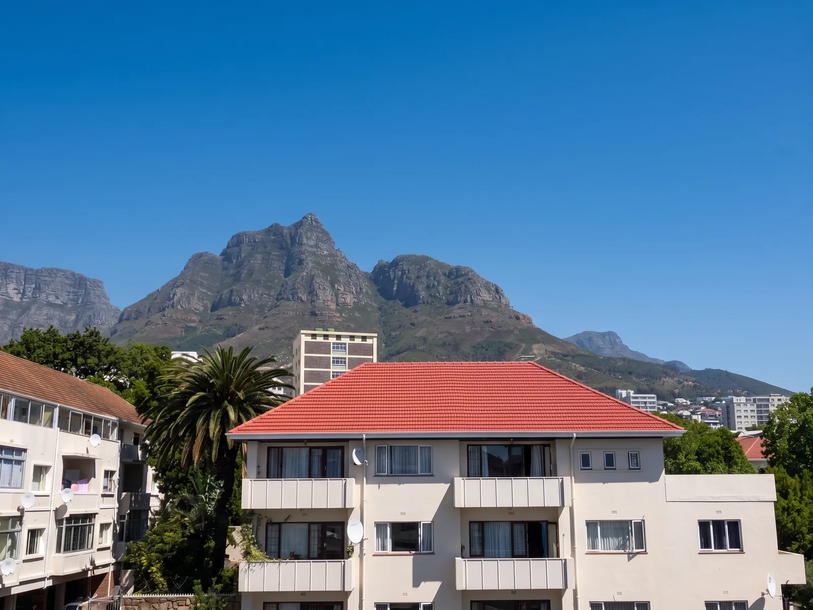 Exmoor Court apartments with restored red roof below Devils Peak in Rondebosch