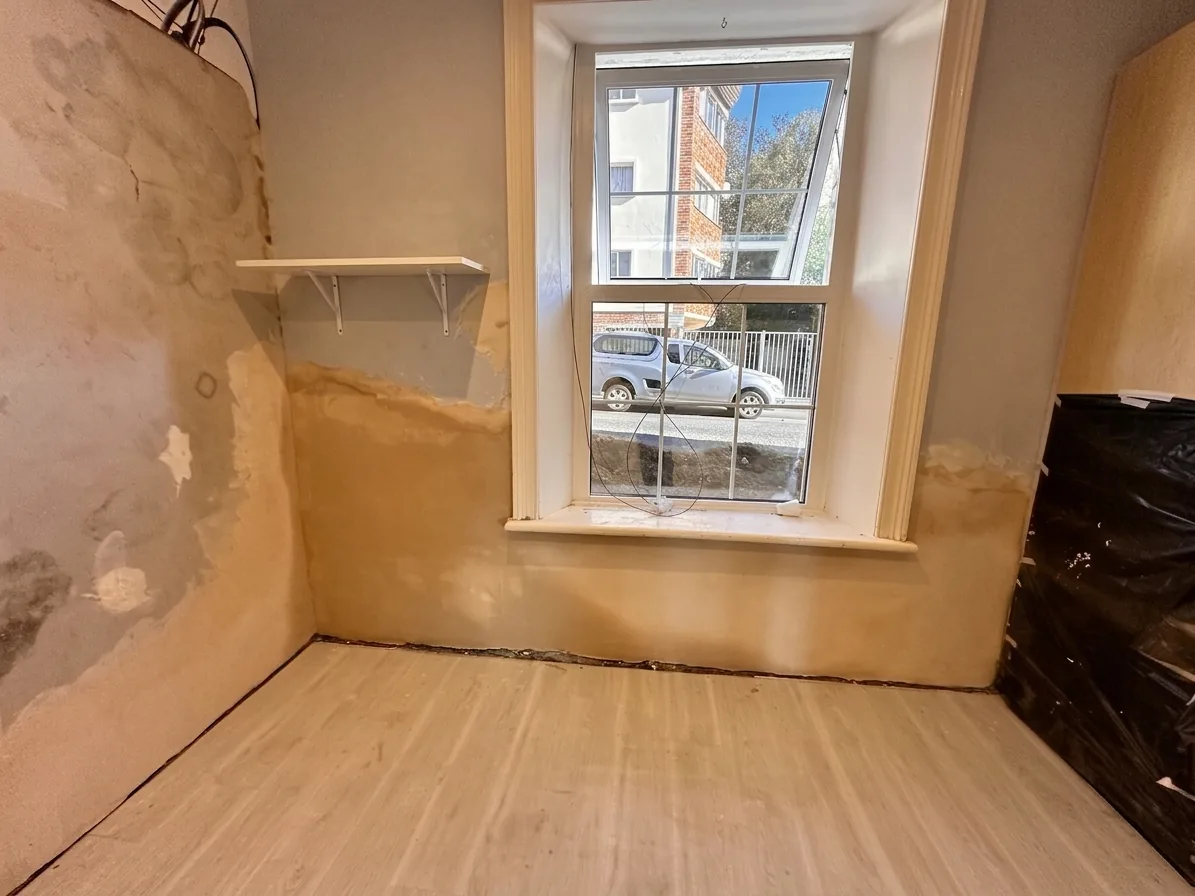 Interior wall stripped back during damp treatment in Rosebank