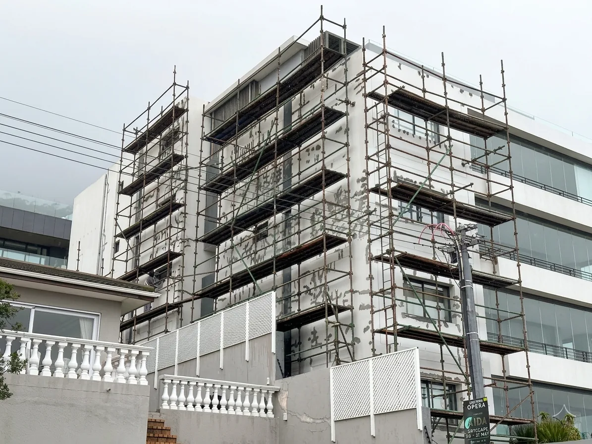 The Brittany under scaffolding during facade preparation and waterproofing in Sea Point